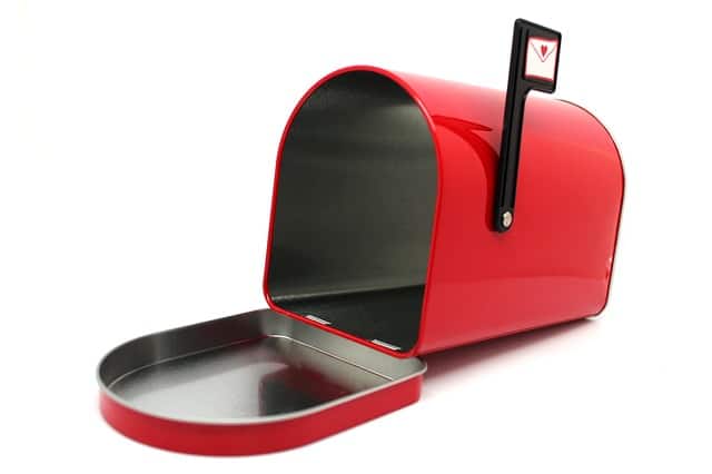 Red mailbox with door open and empty inside, containing no junk mail. Flag is raised and has icon of letter with heart stamp.